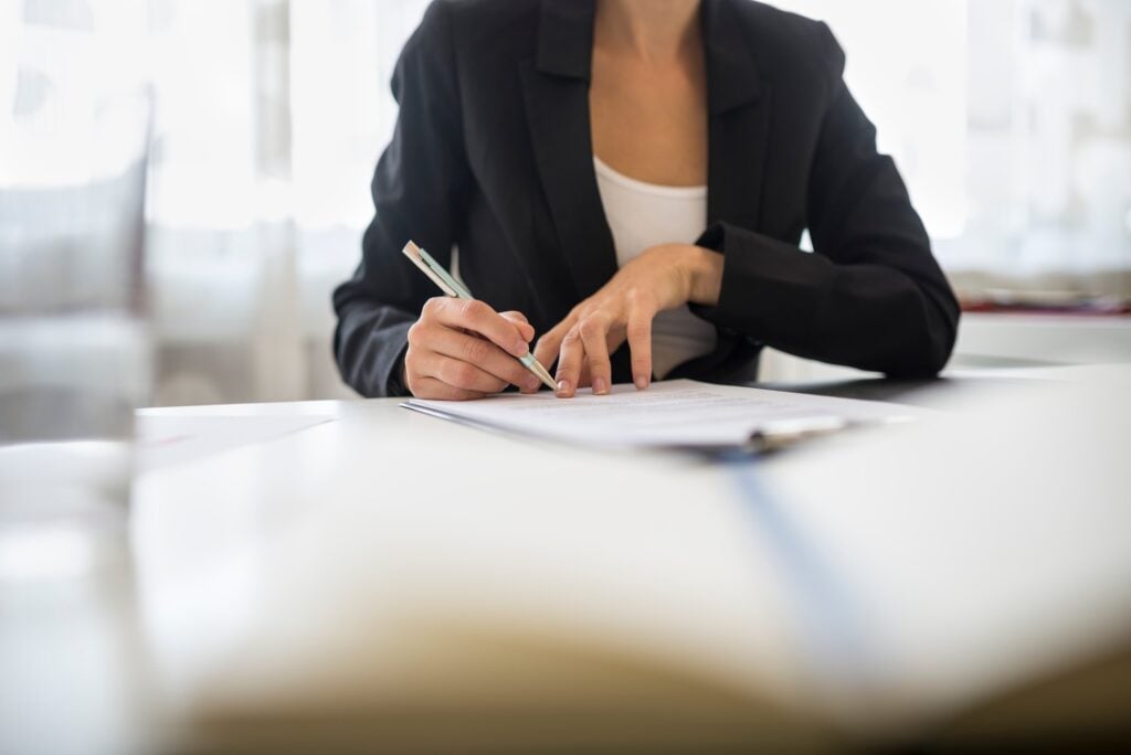 Businesswoman signing a document
