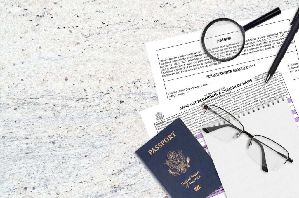 Department of State form DS60 Affidavit Regarding a change of name lies on table and ready to fill